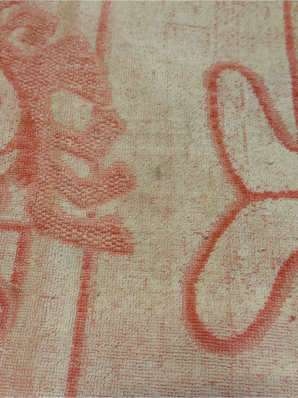 Pink and white 70s beach towel featuring Punchy, the Hawaiian Punch Mascot
